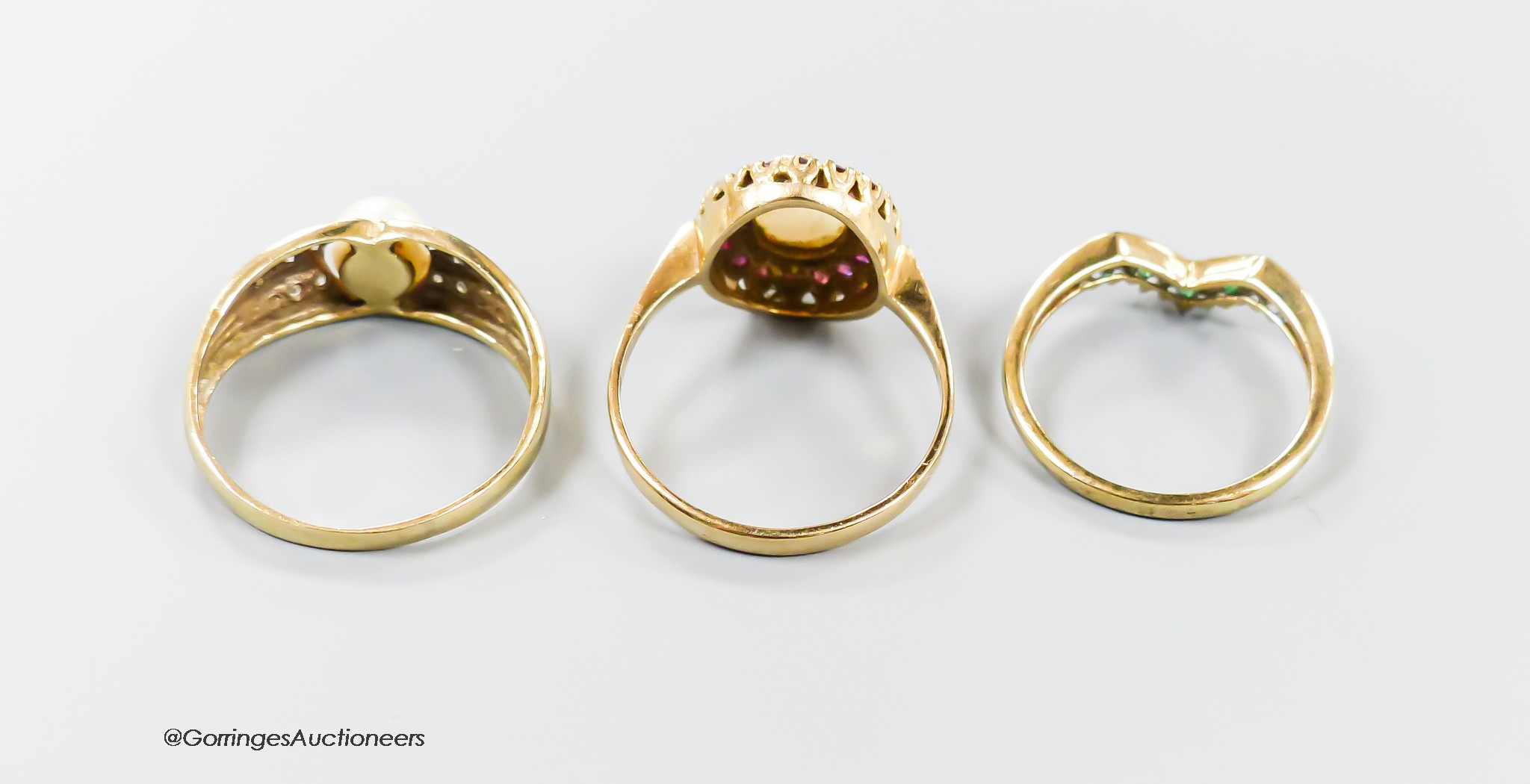 Two 9ct gold and gem set rings, ruby and white opal cluster and emerald and diamond herringbone and a 375 and cultured pearl ring, gross weight 6.8 grams.